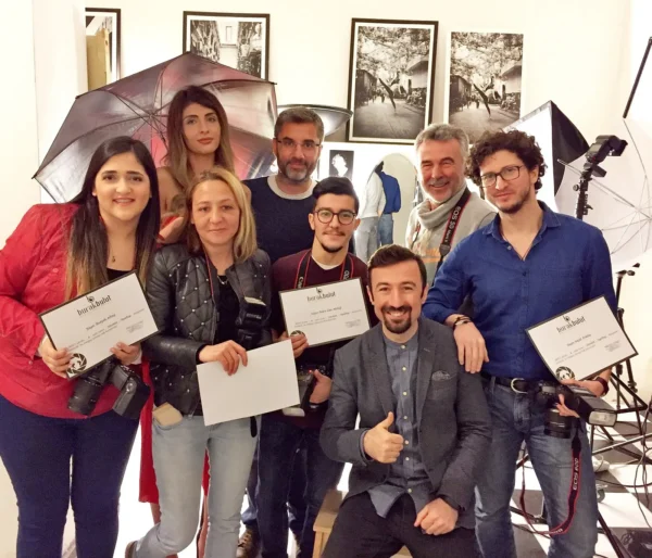 Certified photography training participants in front of studio lights and reflectors, studio shooting and detail-oriented view.